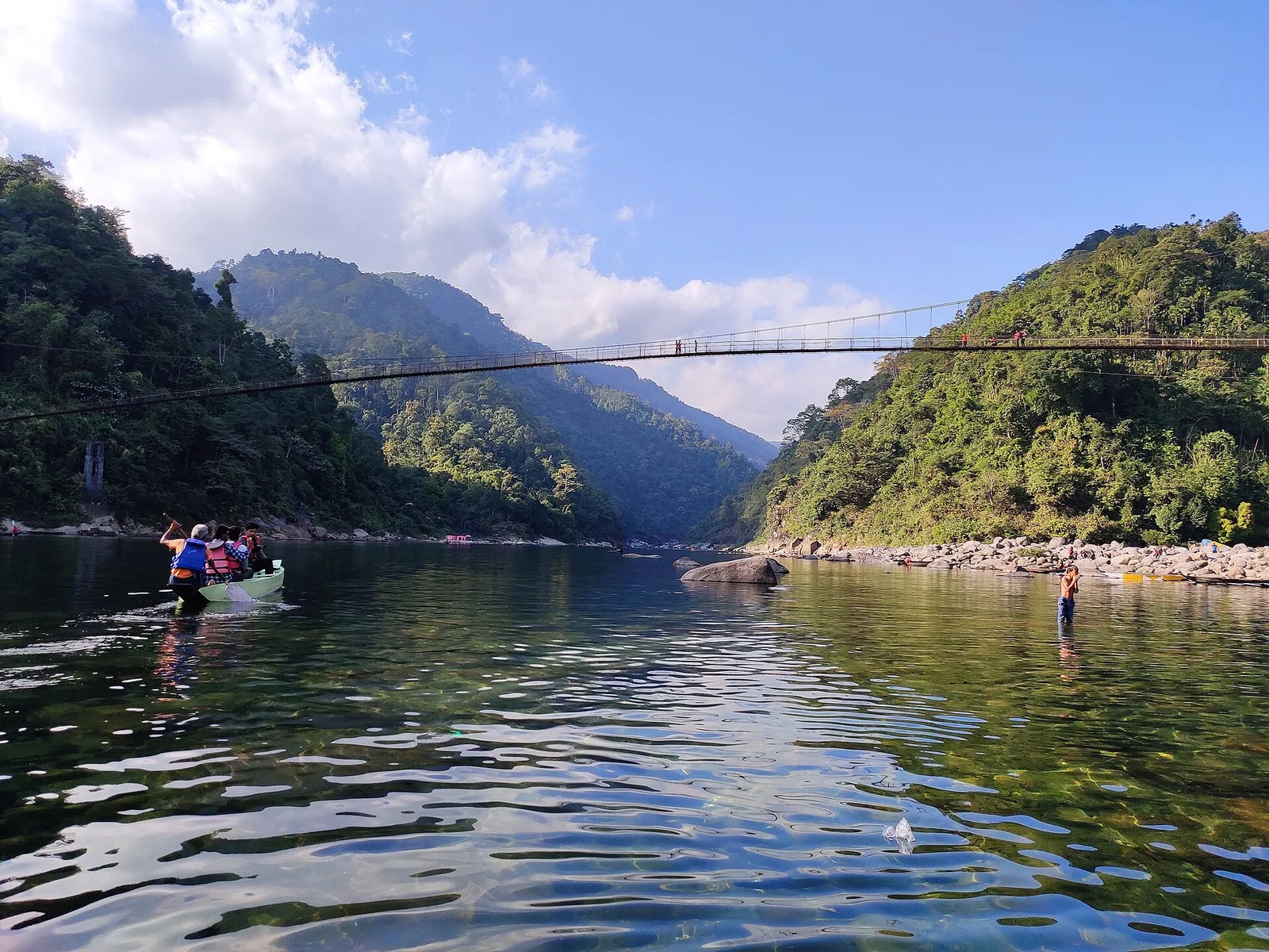 Boats on the clear Umngot river under the Dawki suspension bridge, Meghalaya