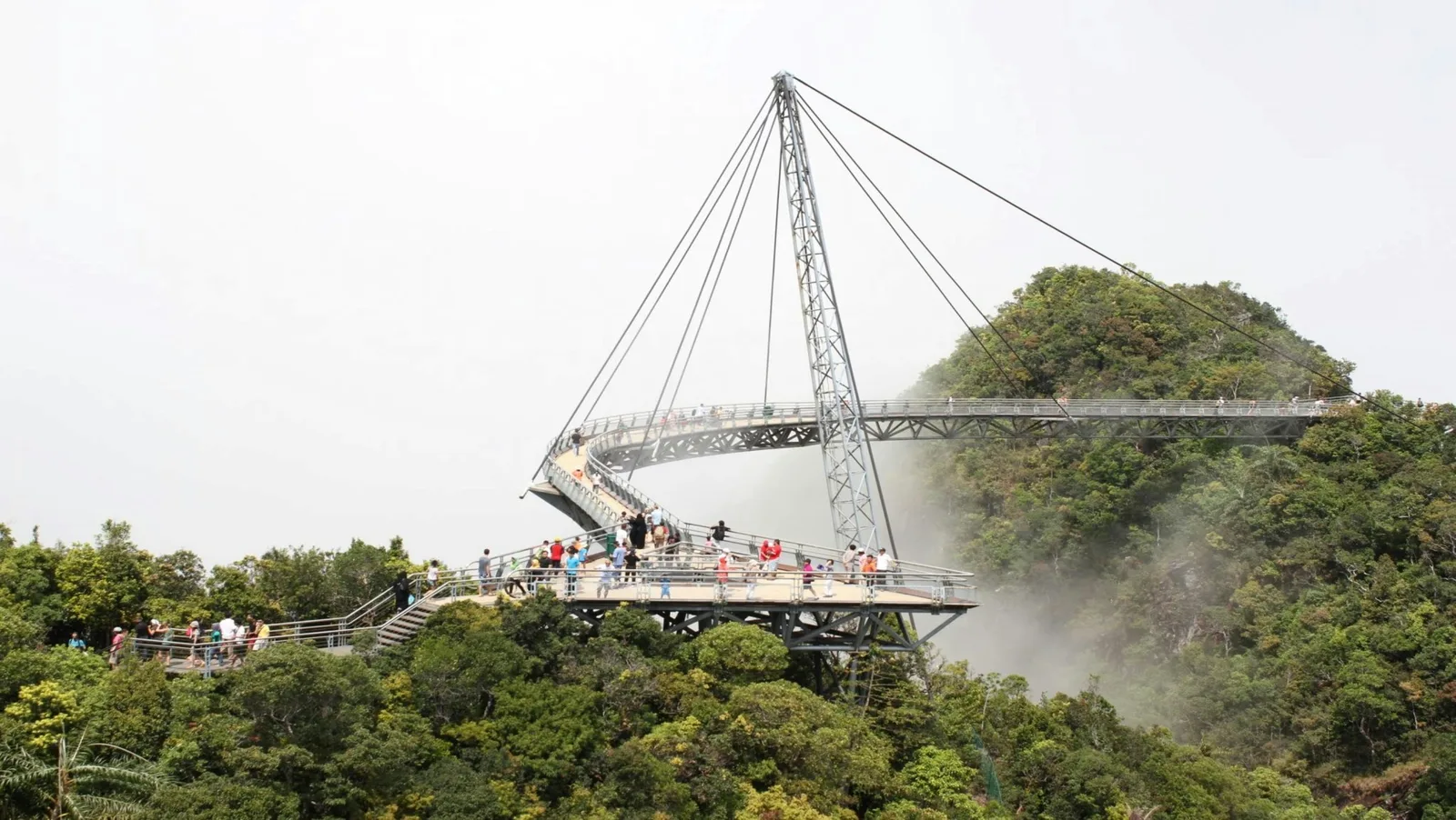 Suspended Langkawi Sky Bridge surrounded by lush green forest in Malaysia