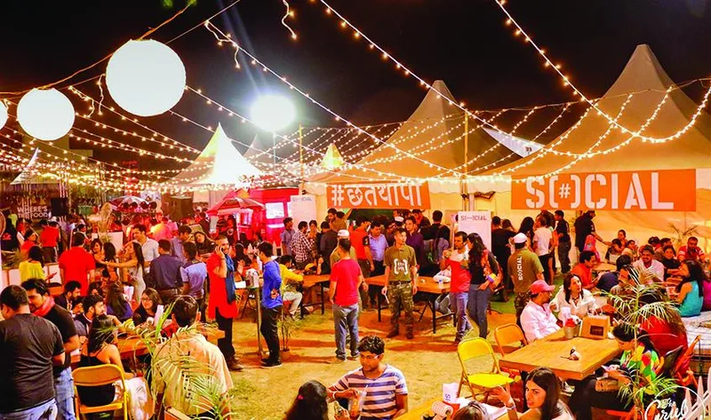 colourful night view of people enjoying in food festival.