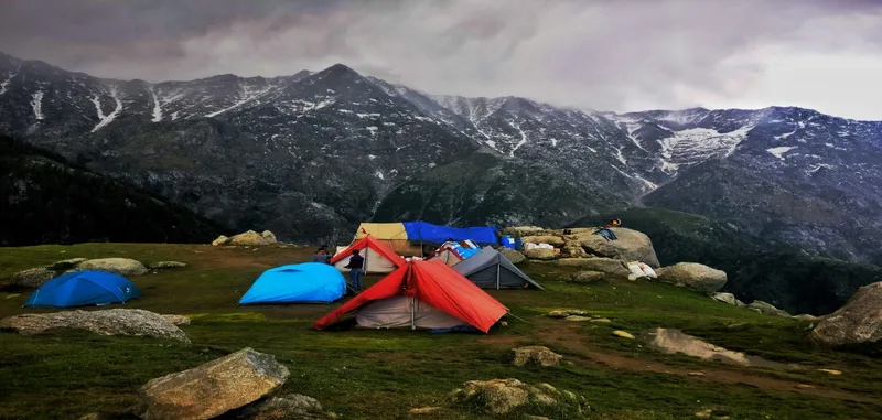mountains surrounded with snow and living in tents near snowy mountains